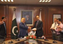 CCO PIA Air Vice Marshal Aamir Hayat presenting the document of the mutual cooperation agreement to Chairman Air Karachi, Hanif Gohar